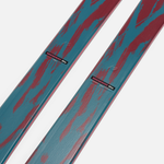 Close-up of teal and red ski surface with K2 branding near binding