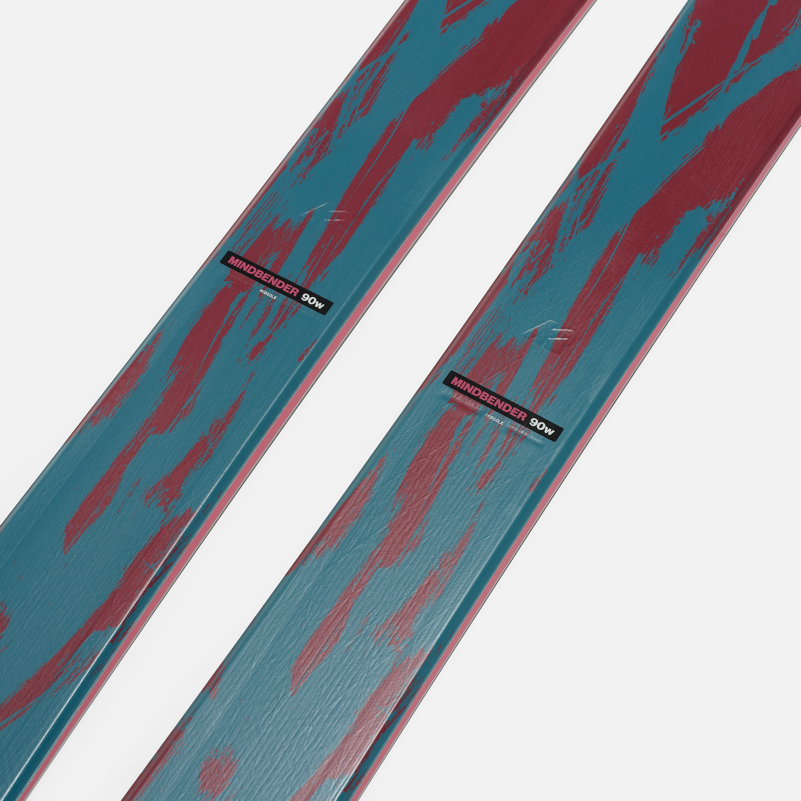 Close-up of teal and red ski surface with K2 branding near binding