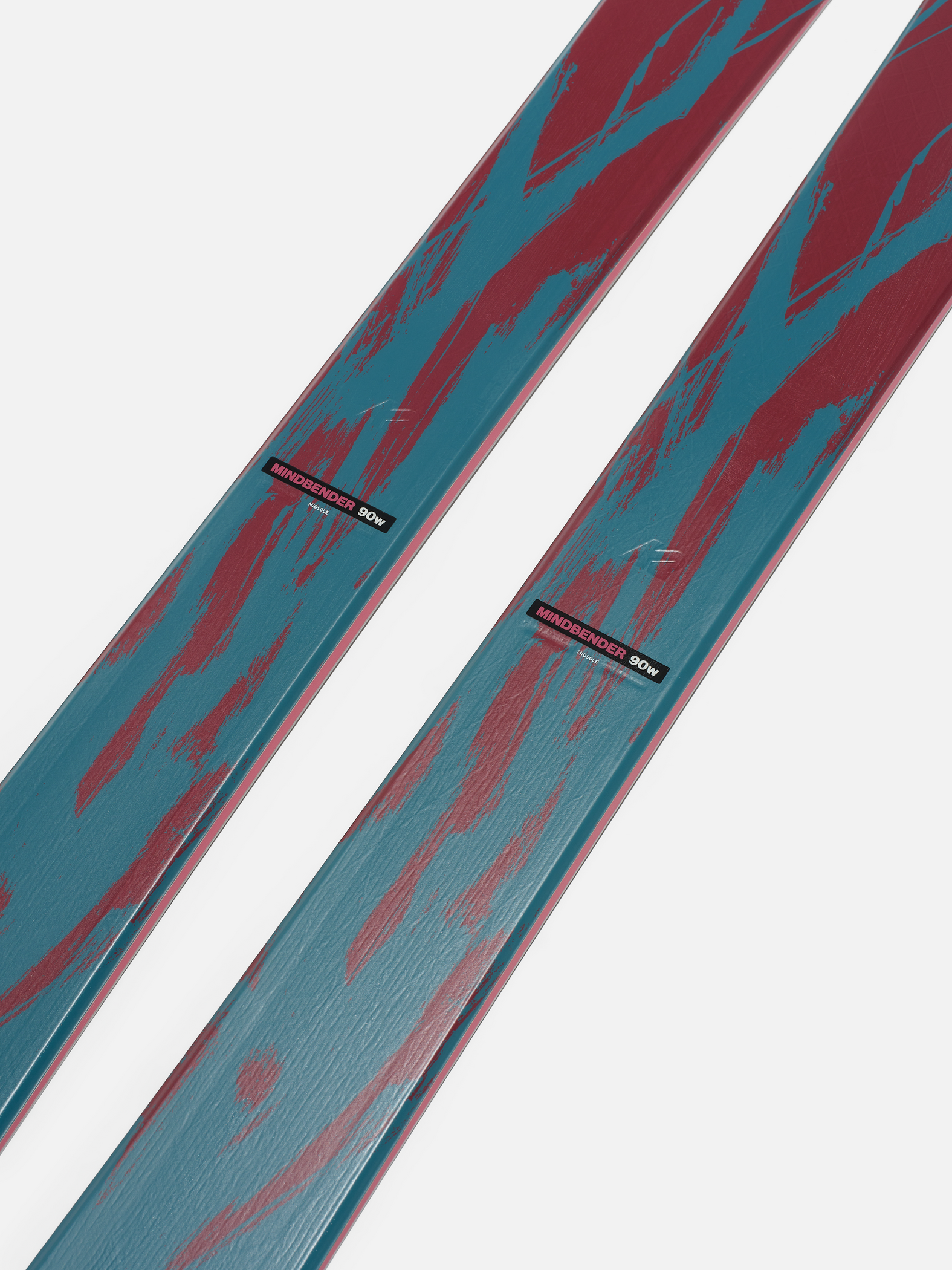 Close-up of teal and red ski surface with K2 branding near binding