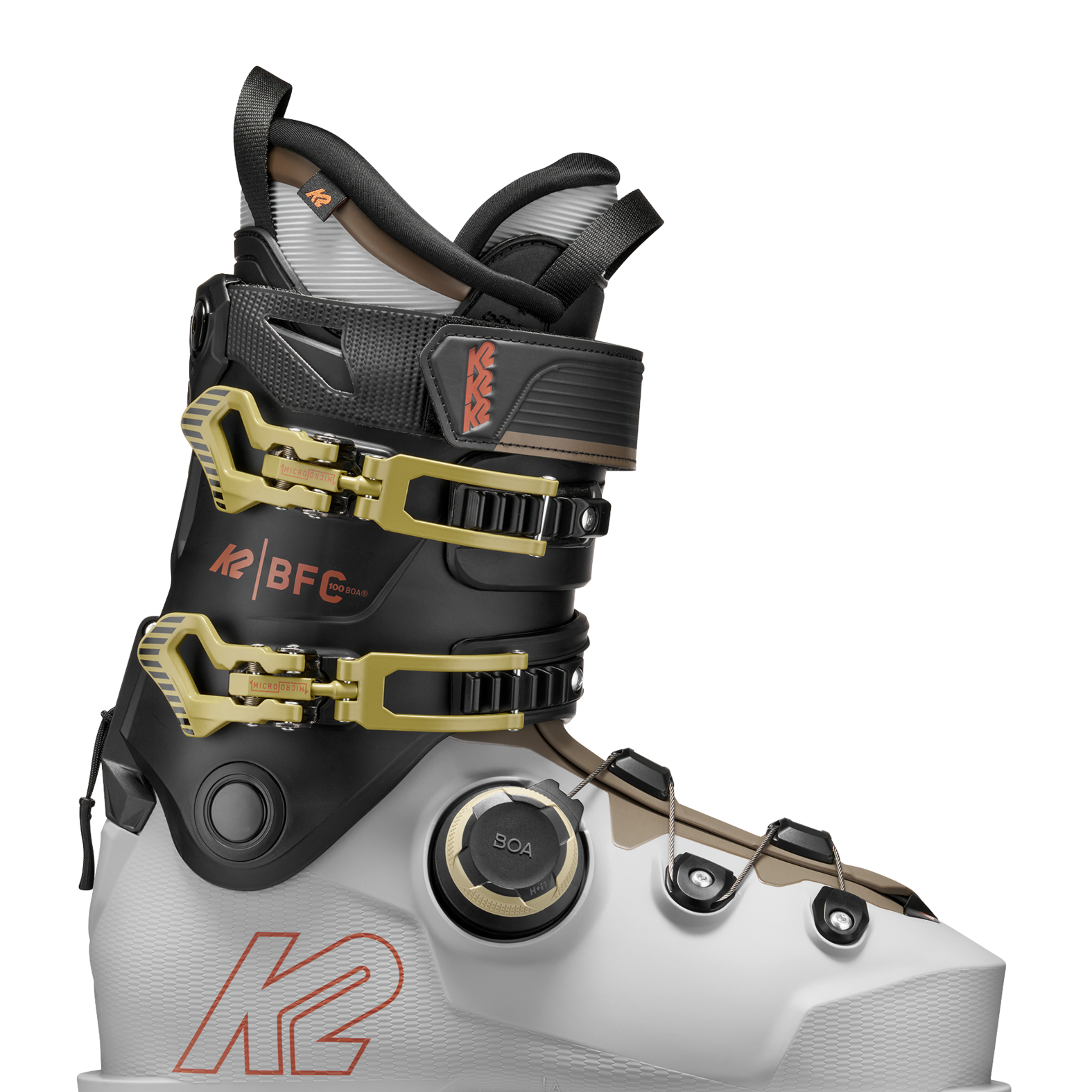 White/black BOA ski boots with gold buckles and black ankle strap