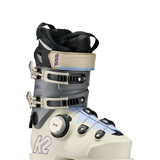 White and grey women's ski boots, side view, with BOA dial and strap buckles