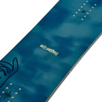 K2 Dreamsicle snowboard features a dark blue design with white graphics.
