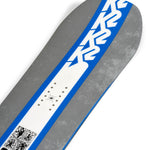 K2 Geometric snowboard 2025 features a dark gray top with blue and white graphic details.