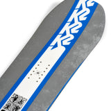 K2 Geometric snowboard 2025 features a dark gray top with blue and white graphic details.