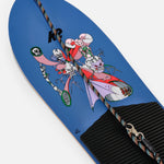 LIMITED EDITION: K2 x Brain Dead Tree Splitter Snowboard 2025 - A blue snowboard with a graphic of three skeletons in red, pink and purple outfits on the top.