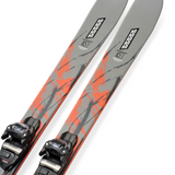 Gray skis with orange graphic streaks and mounted black bindings, angled close-up