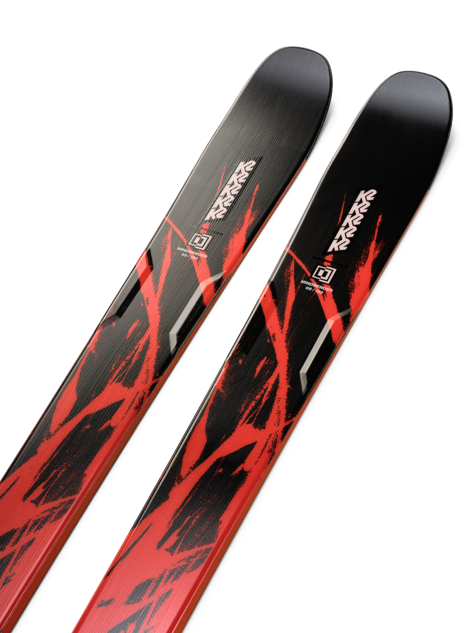 K2 Mindbender 88 skis, angled close-up of red and black topsheets