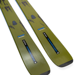 Ski tips and bases in olive/yellow with blue decals, close angled view