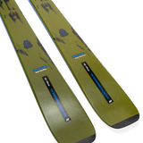 Ski tips and bases in olive/yellow with blue decals, close angled view