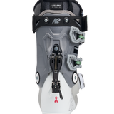 White and grey women’s ski boots with BOA dial and back strap, green details