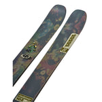 K2 Reckoner 102 skis feature a vibrant green and purple graphic design.