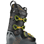 Black ski boot with neon green buckles and strap, side view