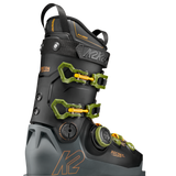Black ski boot with neon green buckles and strap, side view