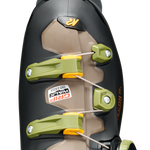 Black ski boot cuff with neon green buckles and beige liner panel, close-up