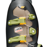 Black ski boot cuff with neon green buckles and beige liner panel, close-up