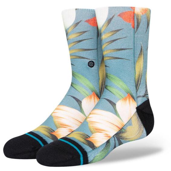 Stance Kid's Tropical Trollin Crew Sock 2023 - A pair of crew socks with a tropical design featuring palm trees and flamingos in shades of pink, green, yellow, and orange on a light blue background.