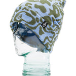 Volcom Women's Shred Beanie 2025 - A light blue beanie with a green abstract pattern and a black tag featuring a white logo on the front.