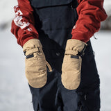 Volcom Women's Peep GORE-TEX Mitt - A pair of tan mittens with a quilted pattern on the palm and thumb, featuring black straps and a black logo patch.