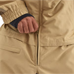 Airblaster Kook Shell Suit 2025 - A tan-colored, long-sleeved jacket with a black zipper and elastic cuffs.