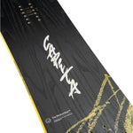 CAPiTA Kazu Kokubo Pro Snowboard 2025 - A black snowboard with a yellow stripe along its edge and silver screws on top.