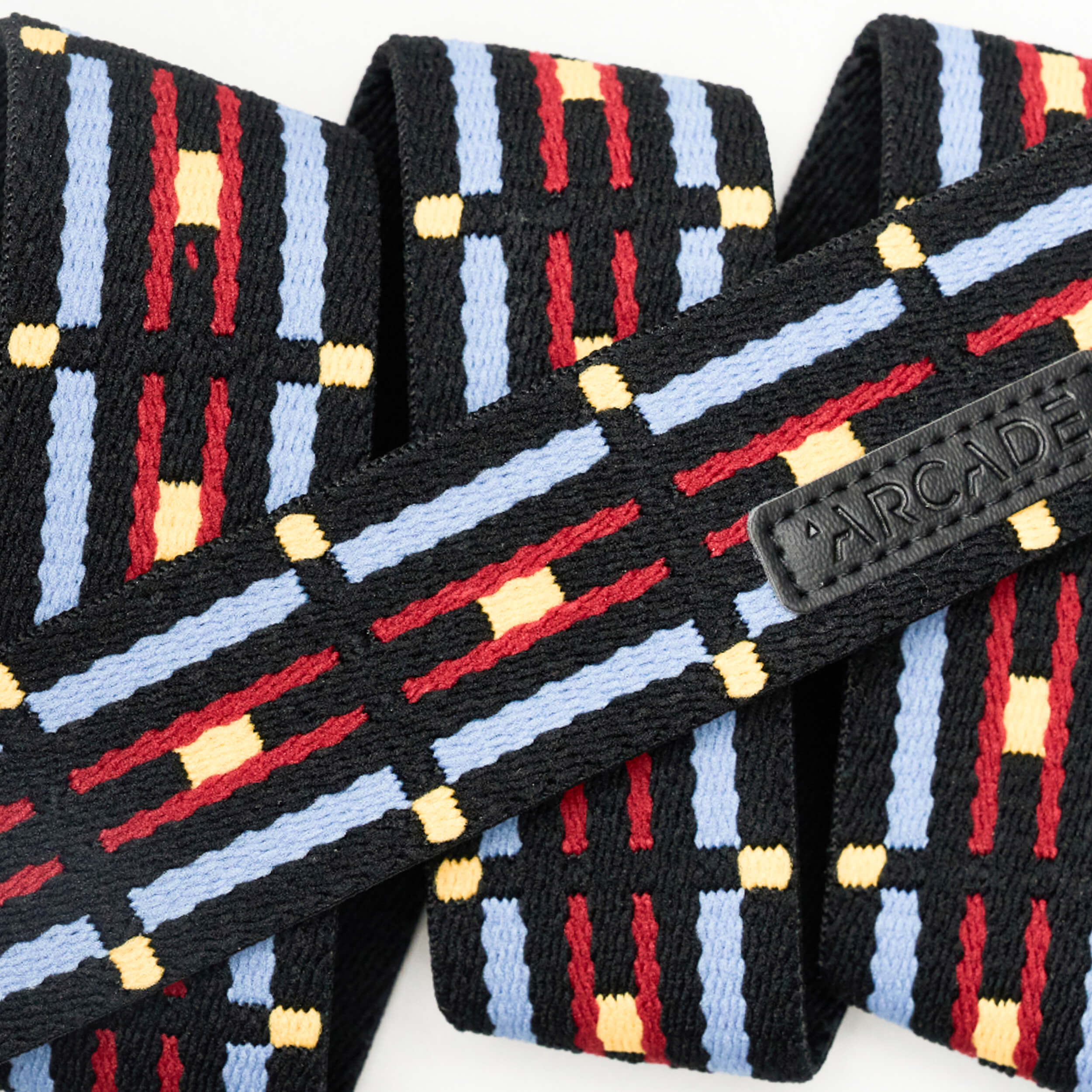 Arcade Vernon Kee Keyah Slim Belt 2025 - A black belt with a repeating pattern of red, blue, and yellow lines.