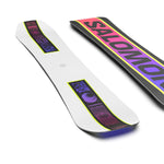 Salomon Junior's Huck Knife Grom Snowboard 2025 - A white snowboard with a black stripe and purple graphics on top, featuring a pink logo that reads "SALOMON" in large letters.