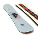 Salomon Kickback Snowboard 2025 - A light gray snowboard with a black and red checkered patterned graphic featuring a silhouette of a person's head in profile, facing left.