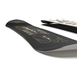 Salomon Women's Wonder Snowboard 2025 - A black snowboard with a gold and white design on top, featuring a woman riding a snowboard in the center.
