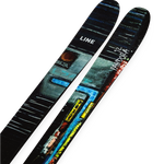 Skis with black tops and vibrant blue-green multicolor artwork, angled view, pair