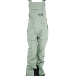 Turbine Women's Longtrail Bib 2025 - A pair of light green bib overalls with a black logo patch on the front pocket.