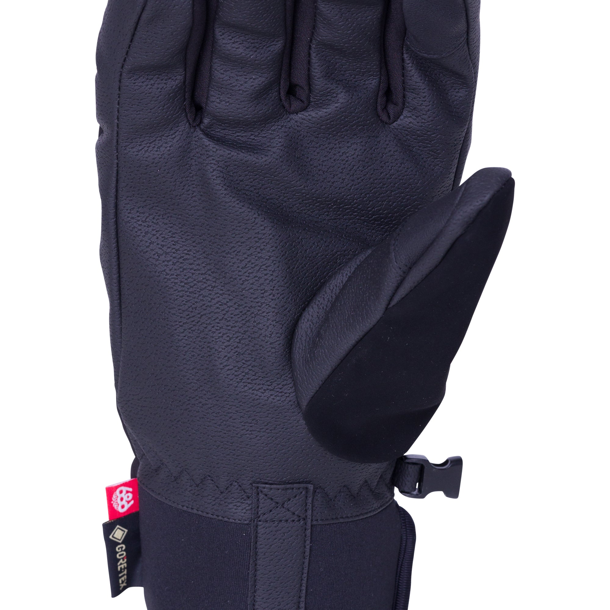 The 686 brand Linear Under Cuff Glove features black Gore-Tex material with a distinctive red tag on its cuff.