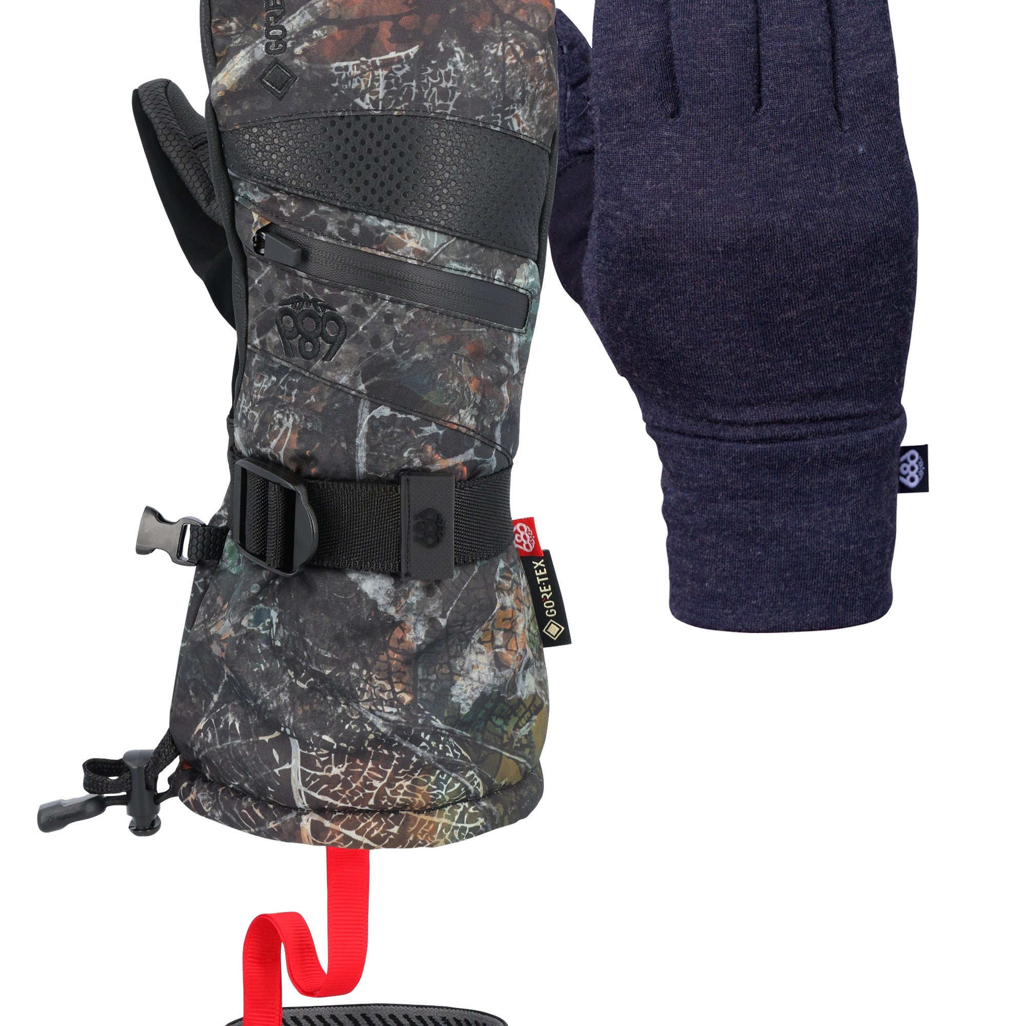 The 686 Women's GORE-TEX SMARTY 3-in-1 Gauntlet Mitt has a black color with a camouflage pattern and a red strap on the wrist, set against a light gray background.