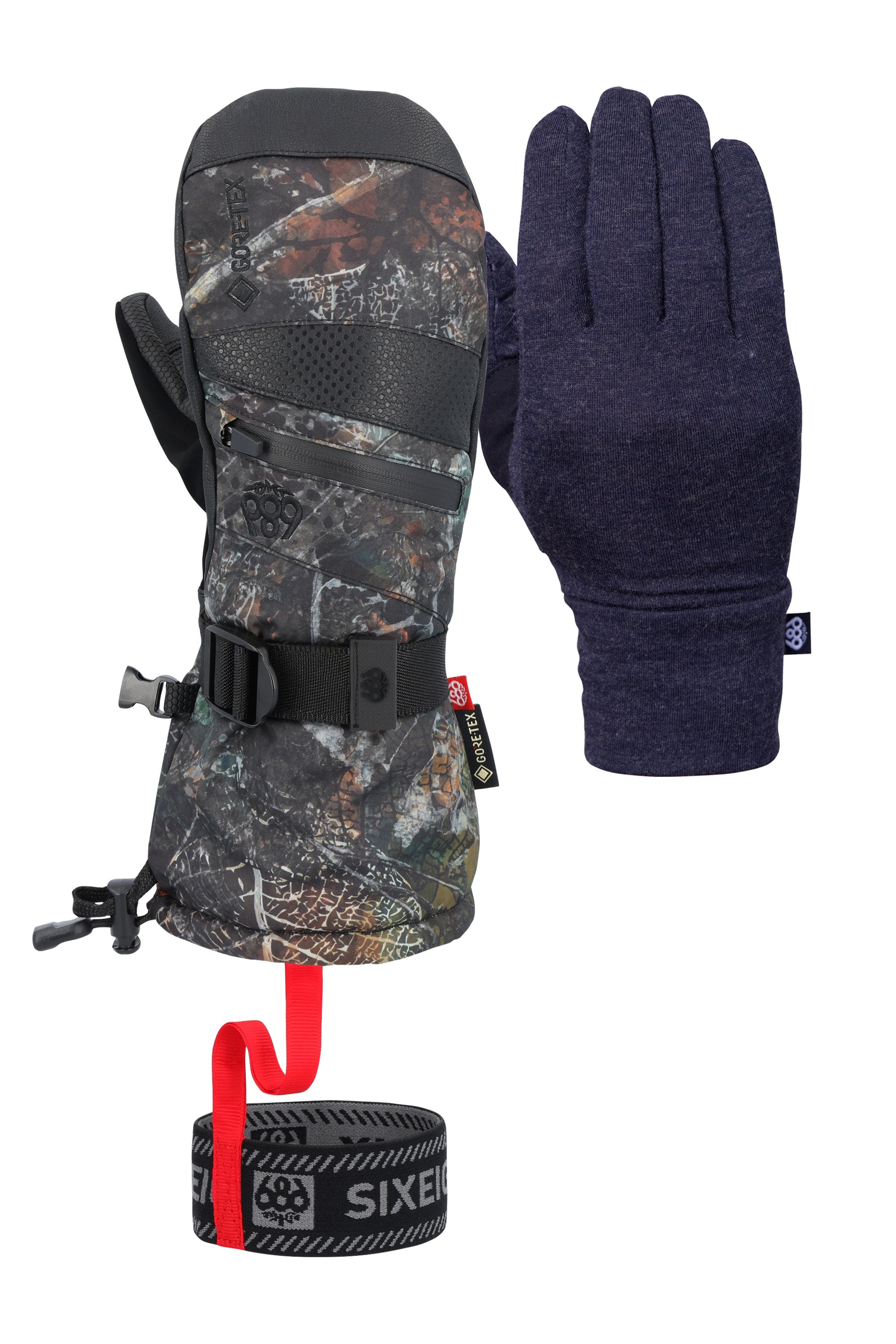 The 686 Women's GORE-TEX SMARTY 3-in-1 Gauntlet Mitt has a black color with a camouflage pattern and a red strap on the wrist, set against a light gray background.