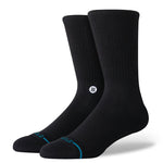 Stance Icon Crew Casual Sock 2025 - A pair of black crew socks with a small white logo on the top of one sock.