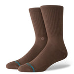 Stance Icon Crew Casual Sock 2025 - A pair of brown crew socks with a small circular logo on the top of one sock's arch.