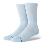 Stance Icon Crew Casual Sock 2025 - A pair of white crew socks with a small logo on the top and teal lettering at the toe.