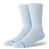 Stance Icon Crew Casual Sock 2025 - A pair of white crew socks with a small logo on the top and teal lettering at the toe.