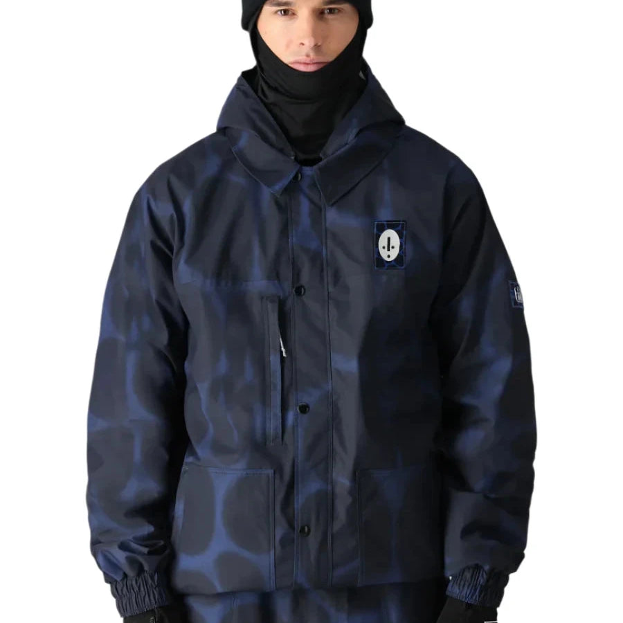 The 686 Dojo Shell Jacket is depicted in dark blue with a subtle leopard pattern and an insulated hood.