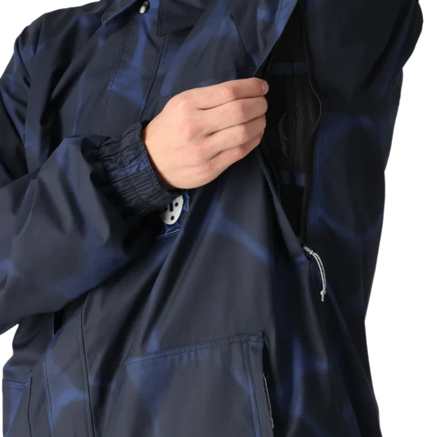 The 686 Dojo Shell Jacket 2025 in navy blue has an insulated hood and front zip closure.