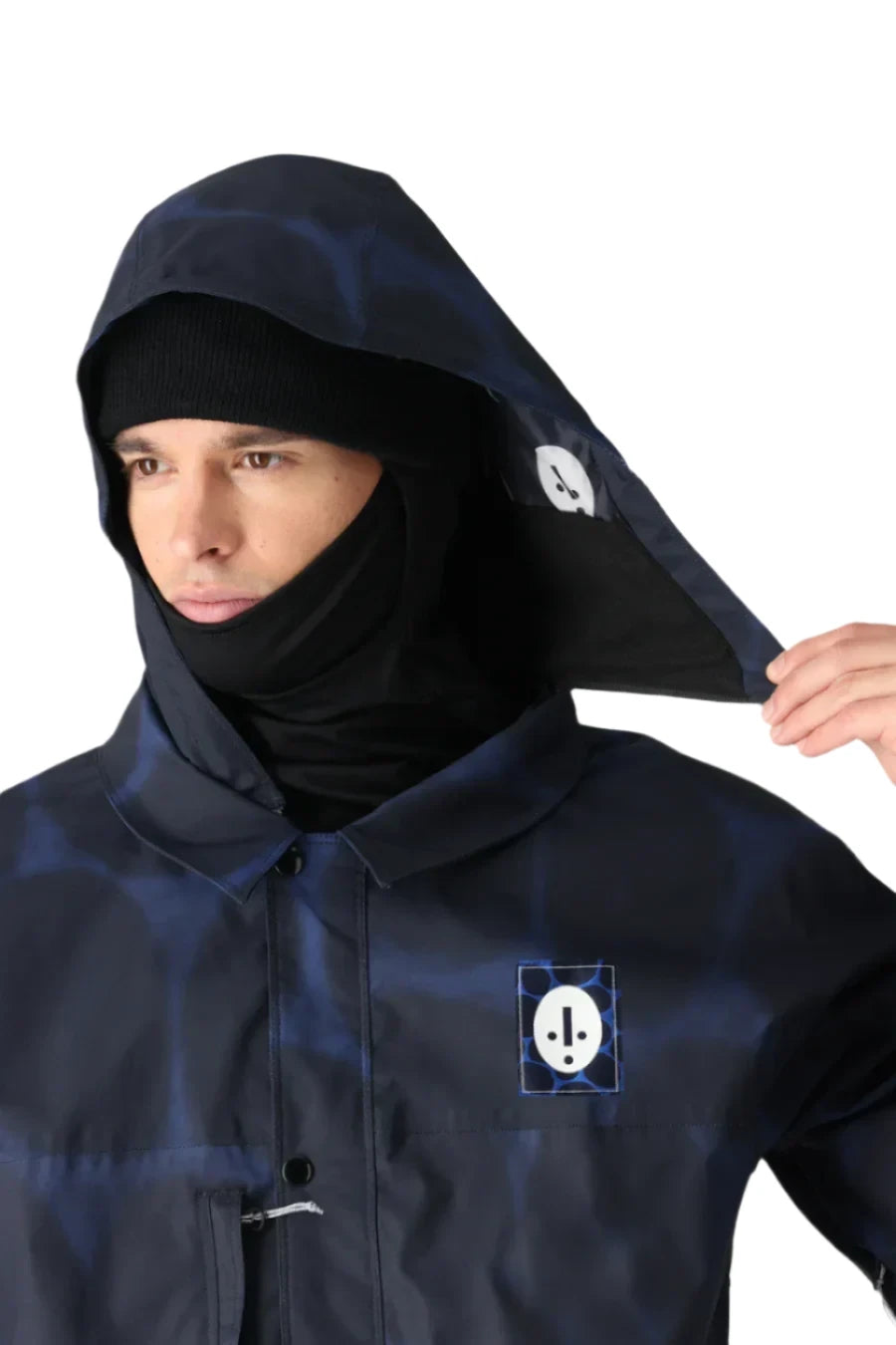 The 686 Dojo Shell Jacket 2025 is shown in navy blue with an insulated hood and a zippered front.