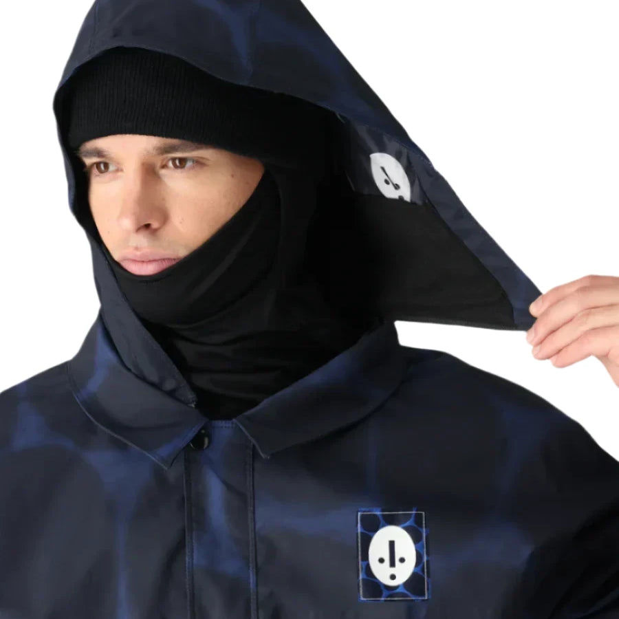 The 686 Dojo Shell Jacket 2025 is shown in navy blue with an insulated hood and a zippered front.