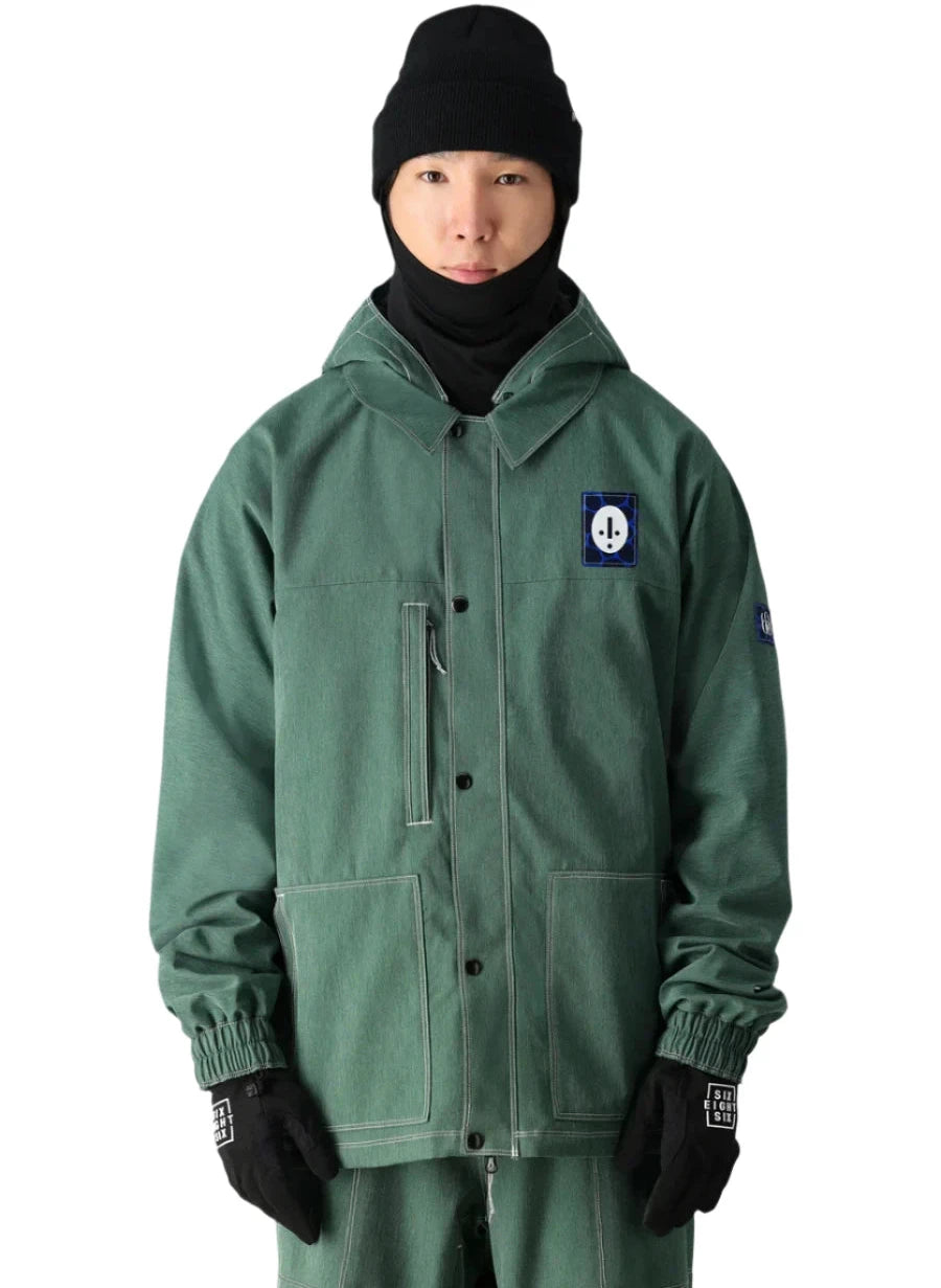 The 686 Dojo Shell Jacket in forest green has an insulated hood and is displayed from the front.