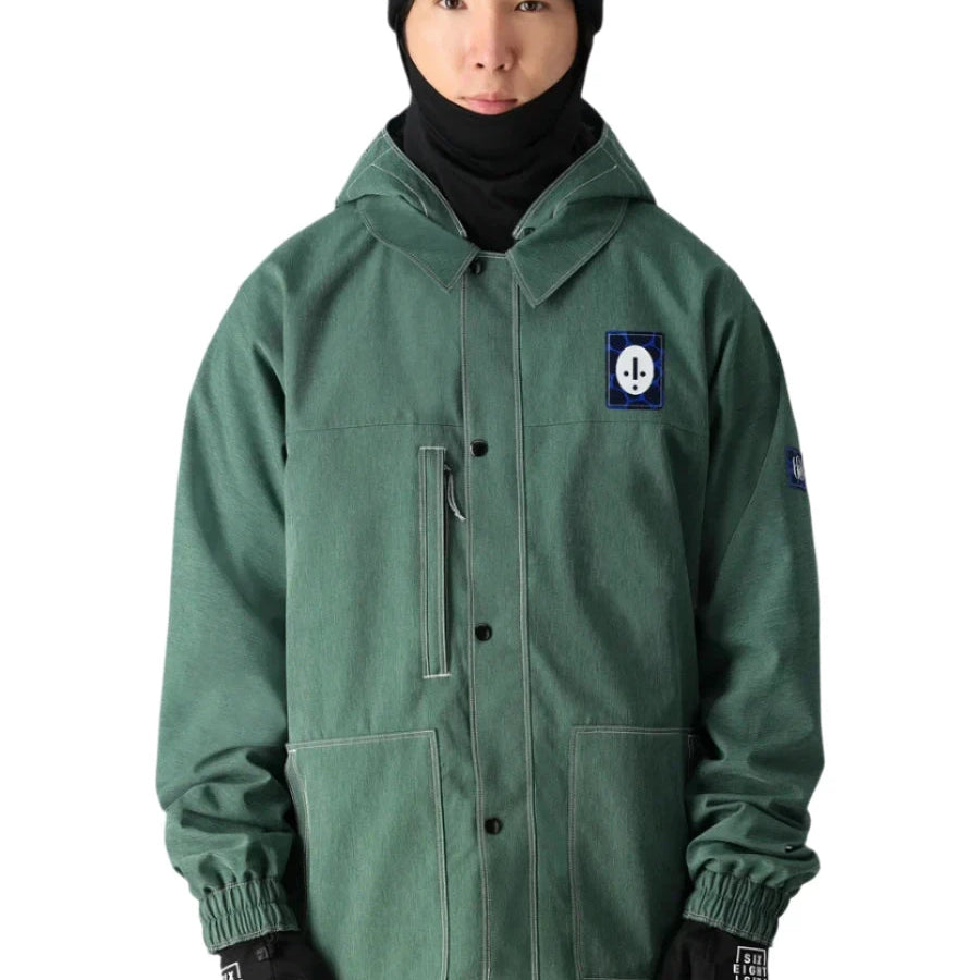 The 686 Dojo Shell Jacket in forest green has an insulated hood and is displayed from the front.