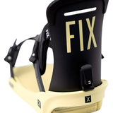 Fix Women's January Snowboard Binding 2024 - A black snowboard binding with a rectangular metal plate and silver screws on top of a cream-colored baseplate.