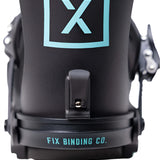 Fix Women's Opus Snowboard Binding 2024 - A black snowboard binding with a light blue logo featuring an "X" and a "P" inside a square.