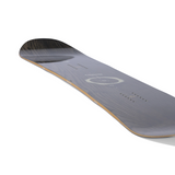 Arbor Women's Mantra Snowboard 2026 - A dark gray snowboard with a circular logo and white lettering on top, featuring a wood grain pattern on its bottom.