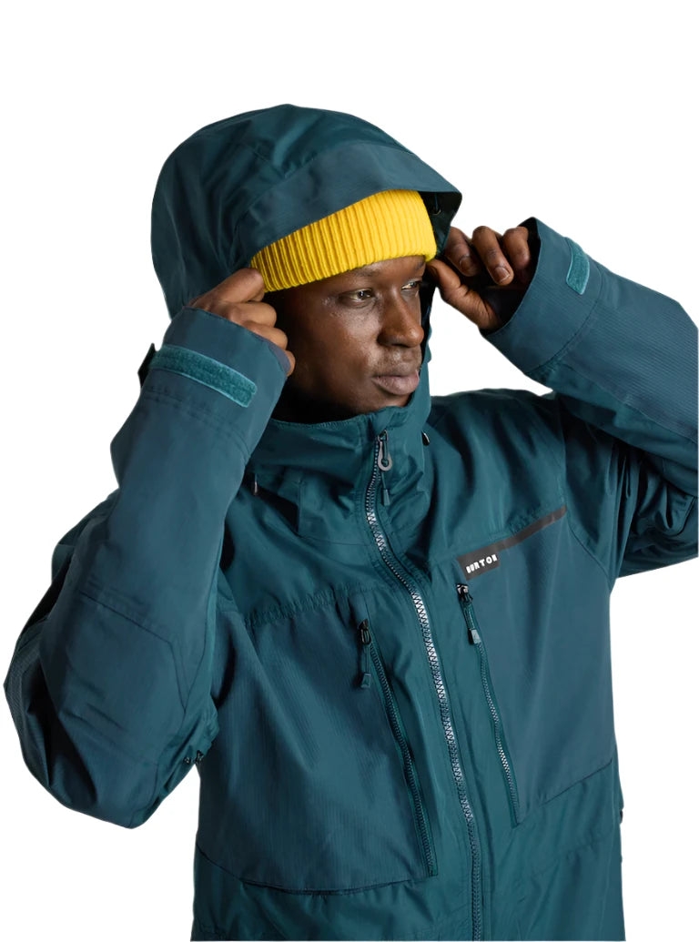 Burton Frostner 2L Jacket 2025 - A dark green jacket with a hood, featuring a zipper and two pockets on the front.