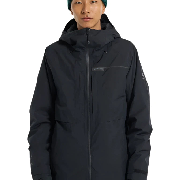 Burton Pillowline GORE-TEX Jacket 2025 - A black jacket with a hood and zippered pockets, featuring a prominent "BURTON" logo on the chest.