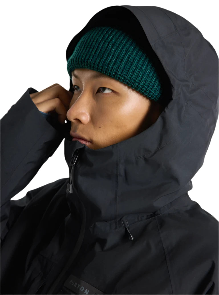 Burton Pillowline GORE-TEX Jacket 2025 - A black jacket with a hood and zipper, featuring a small "BURTON" logo on the chest.