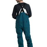 Burton Reserve Bib Pant 2025 - Dark-colored bib pants with a white logo on the left leg and black straps over the shoulders.